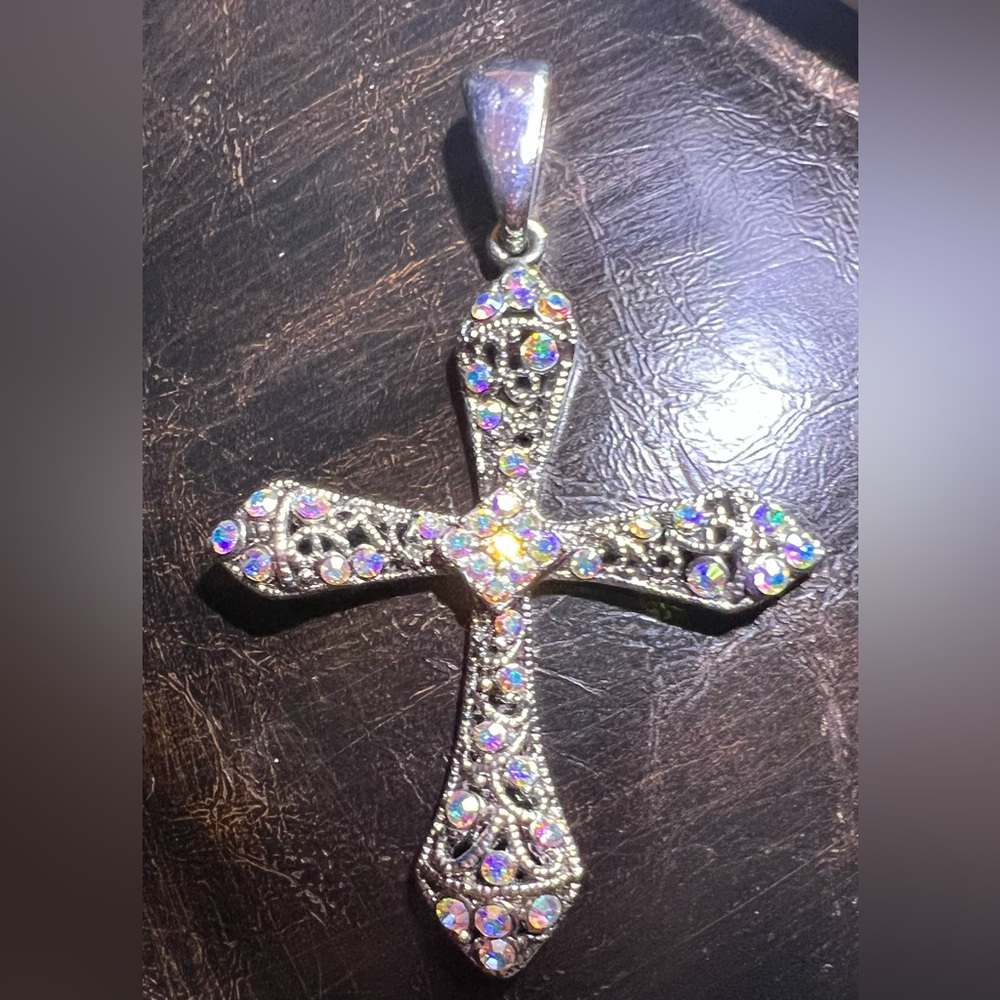Beautiful Crystal and rhinestones cover this Rhodium plated cross
